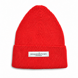 A bright red ribbed knit beanie hat with a folded cuff, featuring a small white rectangular label that reads 'slopes&town Amsterdam'. The beanie is photographed against a clean white background.