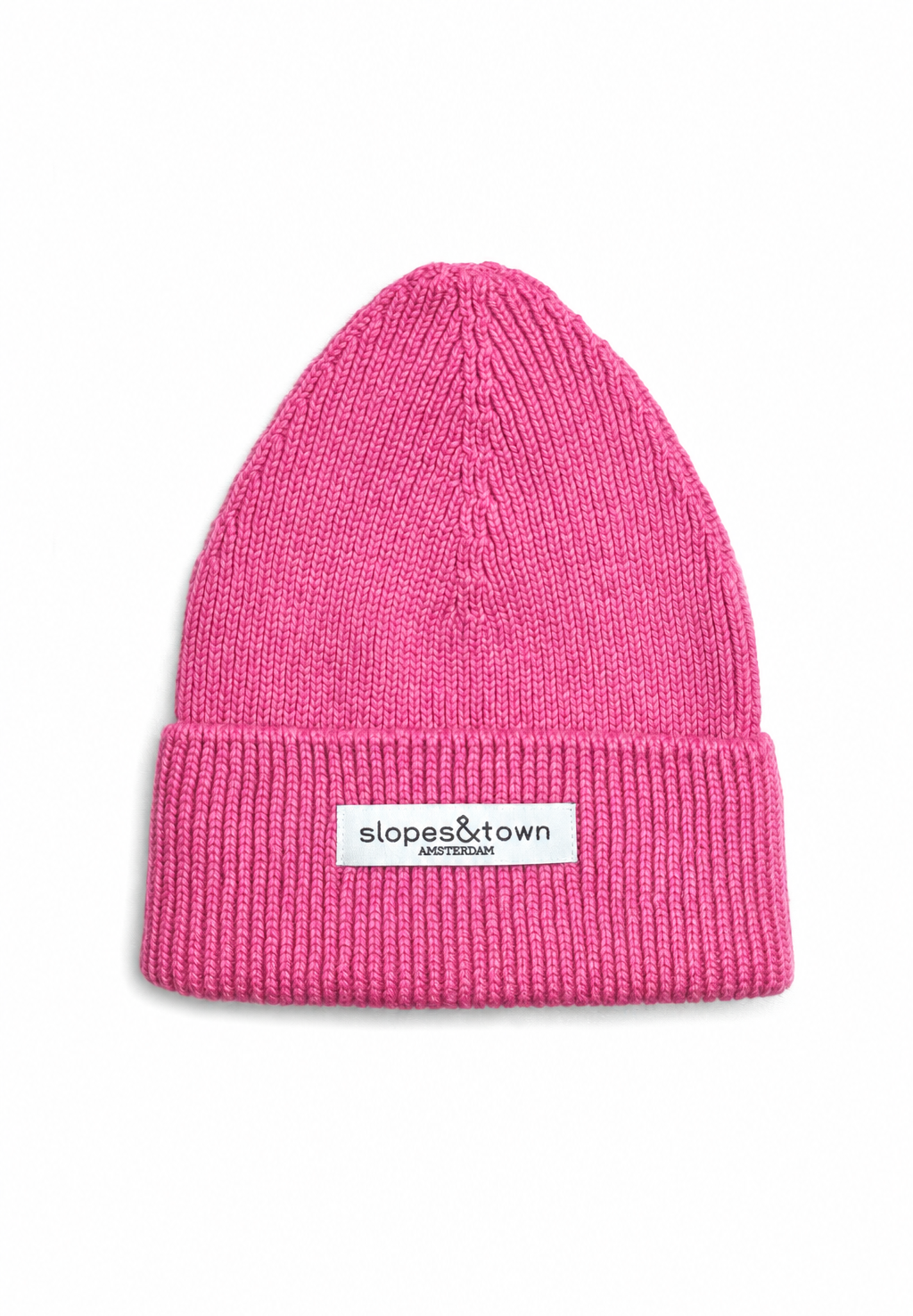 A bright pink ribbed knit beanie hat with a folded cuff and a small white brand label reading 'slopes&town amsterdam' on the front, shown against a plain white background.