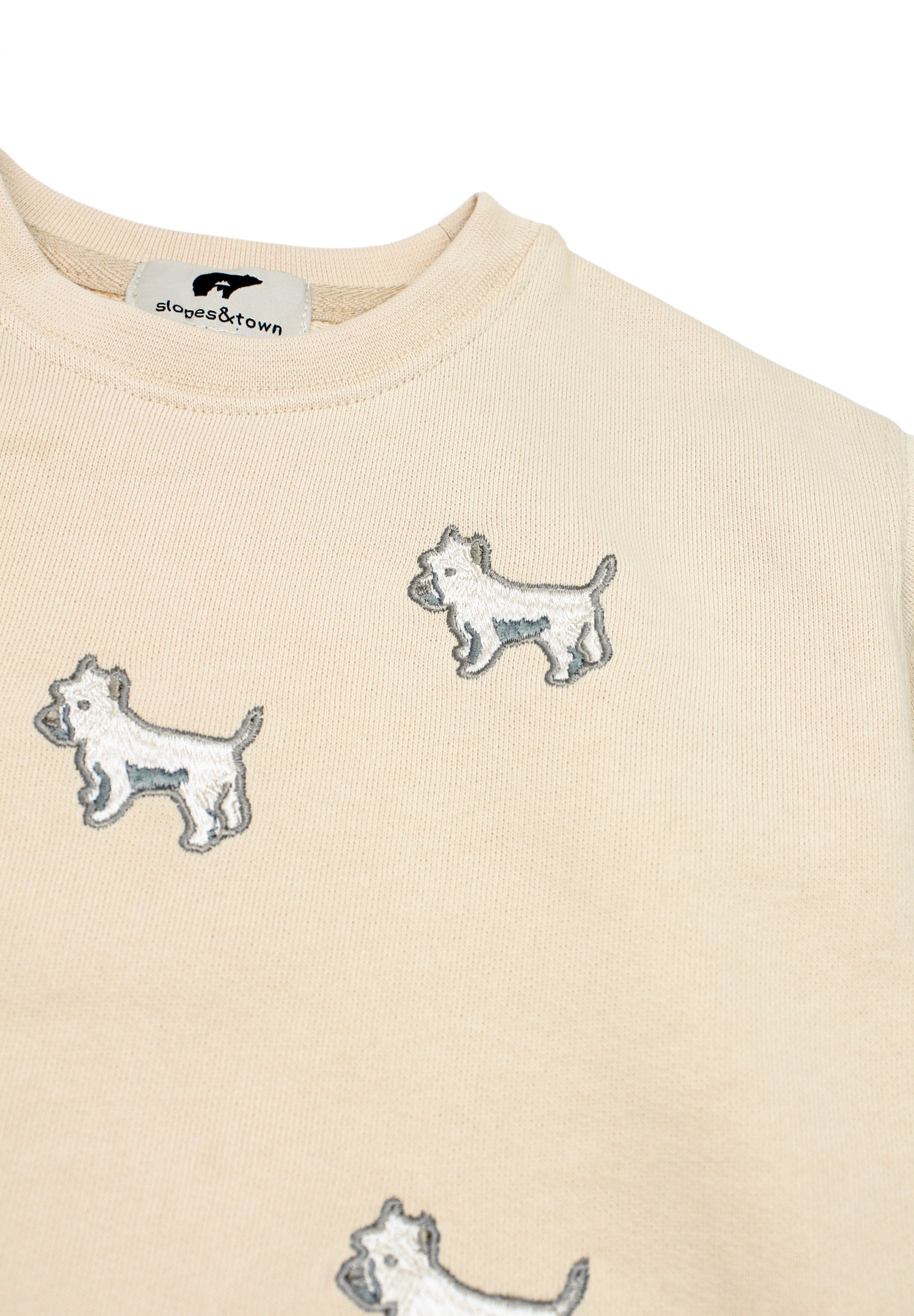 Kids' cream tracksuit featuring embroidered white terrier dog