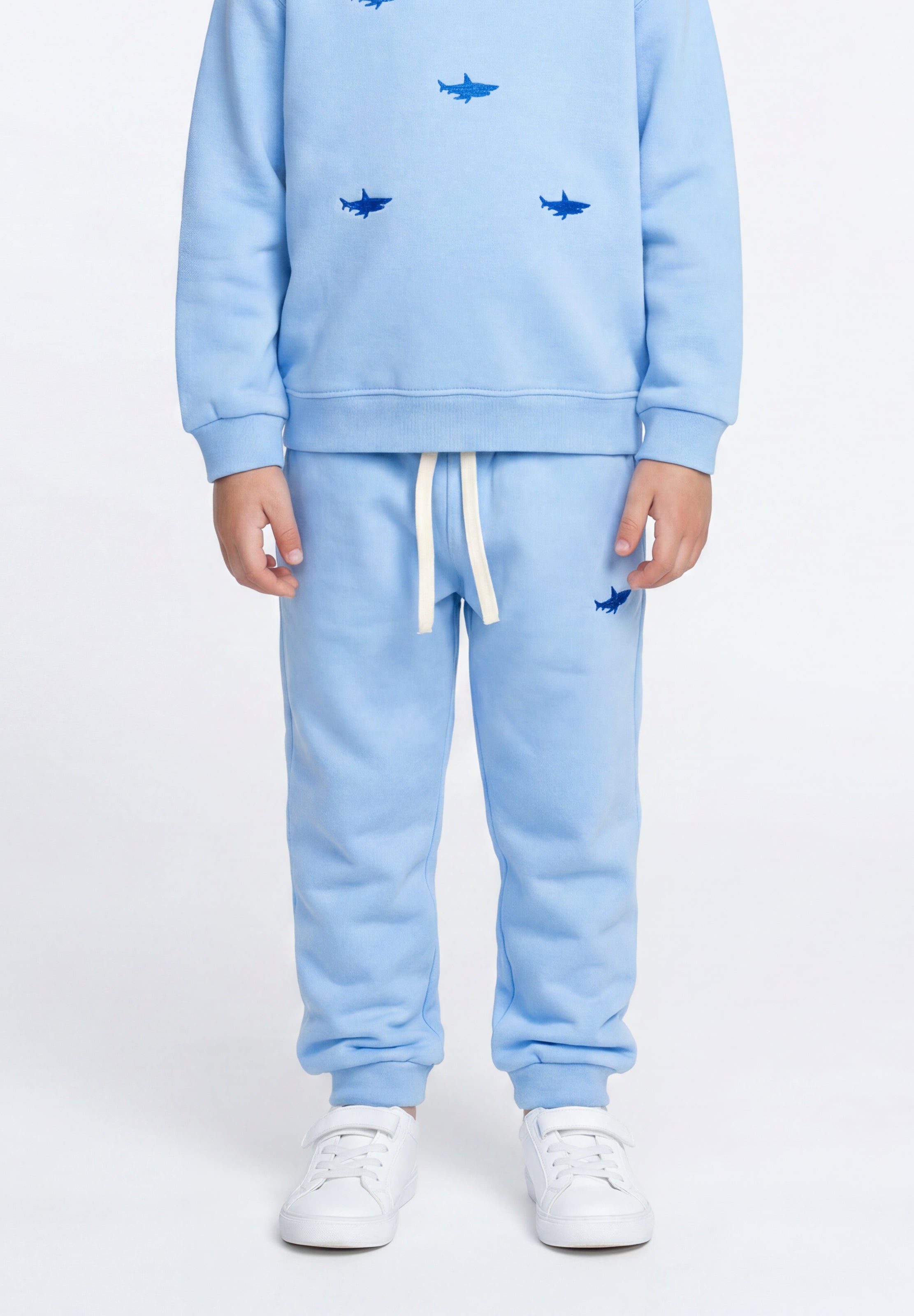 Kids' blue sweatpants featuring shark embroidery