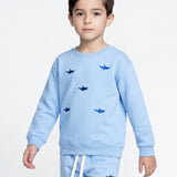 Child wearing light blue organic cotton shark sweatshirt