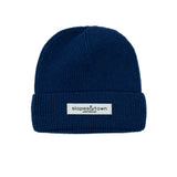 Muts van merinowol voor kinderen in marineblauw, vooraanzicht met geweven label van Slopes and Town Amsterdam