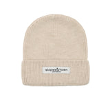 Kids merino wool beanie in latte beige, front view with Slopes and Town Amsterdam woven label
