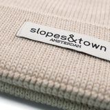 Kids merino wool beanie in latte beige, ribbed knit texture and folded cuff detail