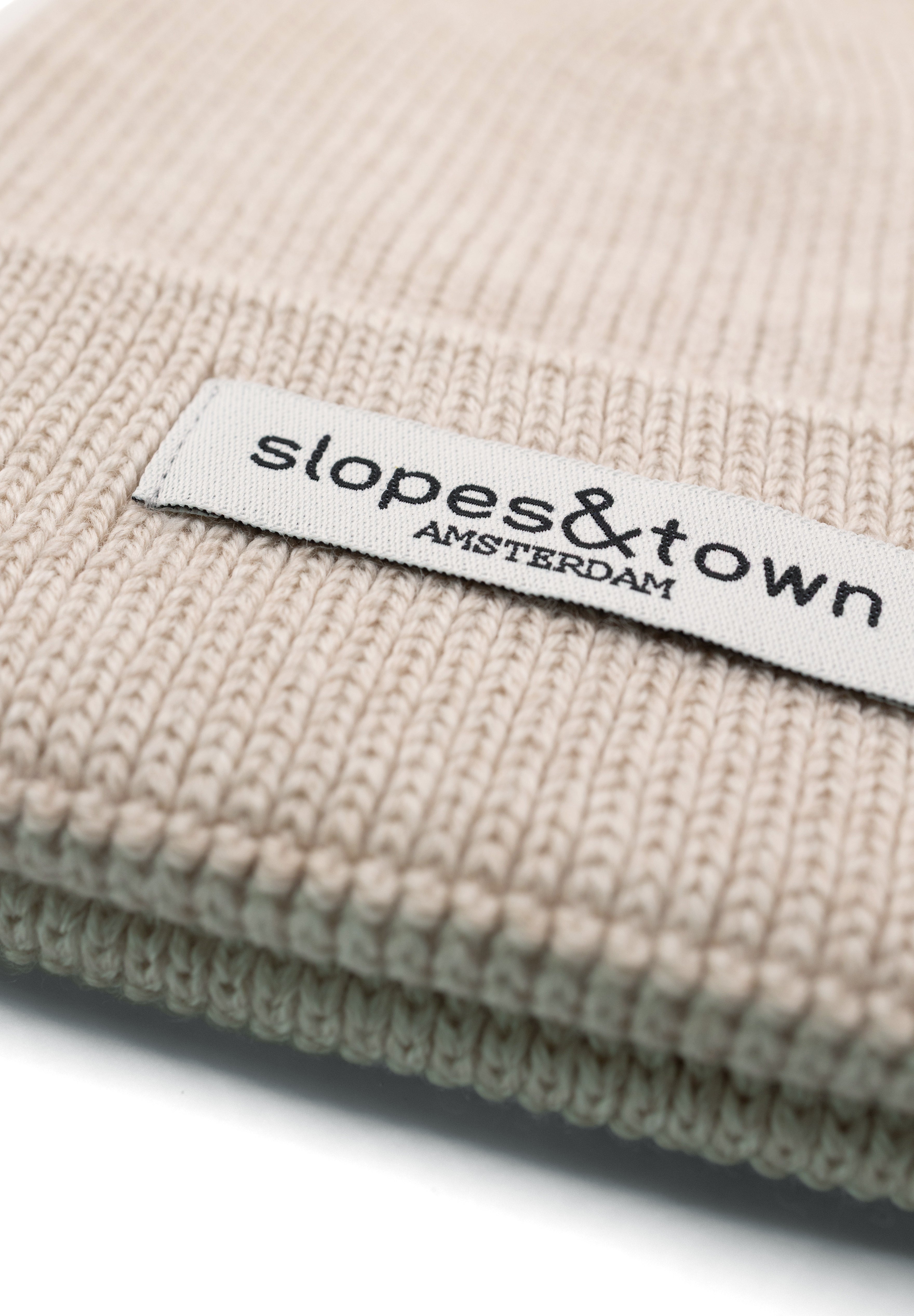 Kids merino wool beanie in latte beige, ribbed knit texture and folded cuff detail