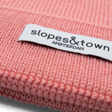 Kids merino wool beanie in lemonade pink, ribbed knit texture and folded cuff detail