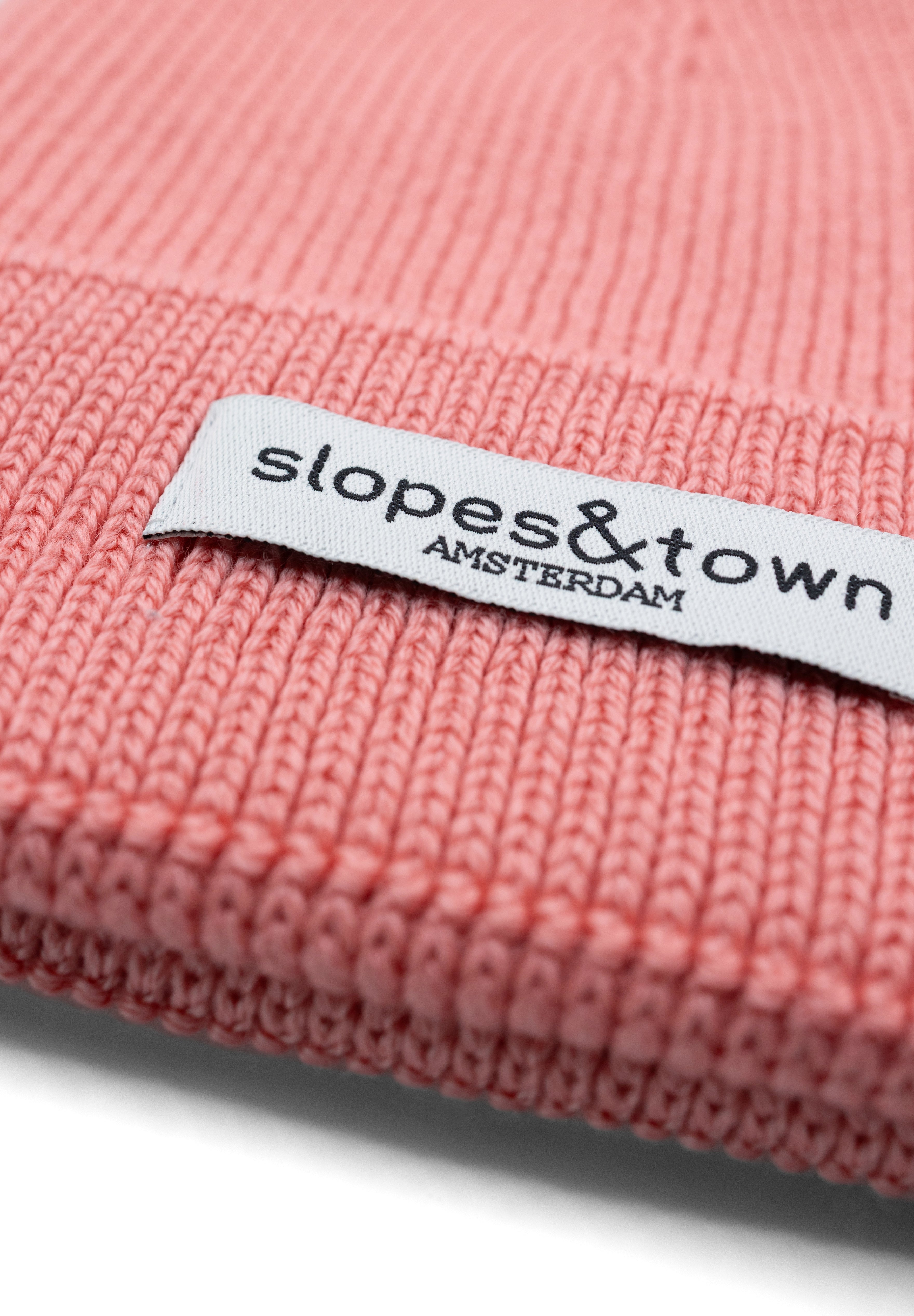 Kids merino wool beanie in lemonade pink, ribbed knit texture and folded cuff detail