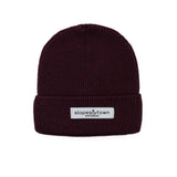 Kids merino wool beanie in burgundy, front view with Slopes and Town Amsterdam woven label