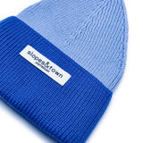 Close-up of merino wool knit on a blue kids beanie
