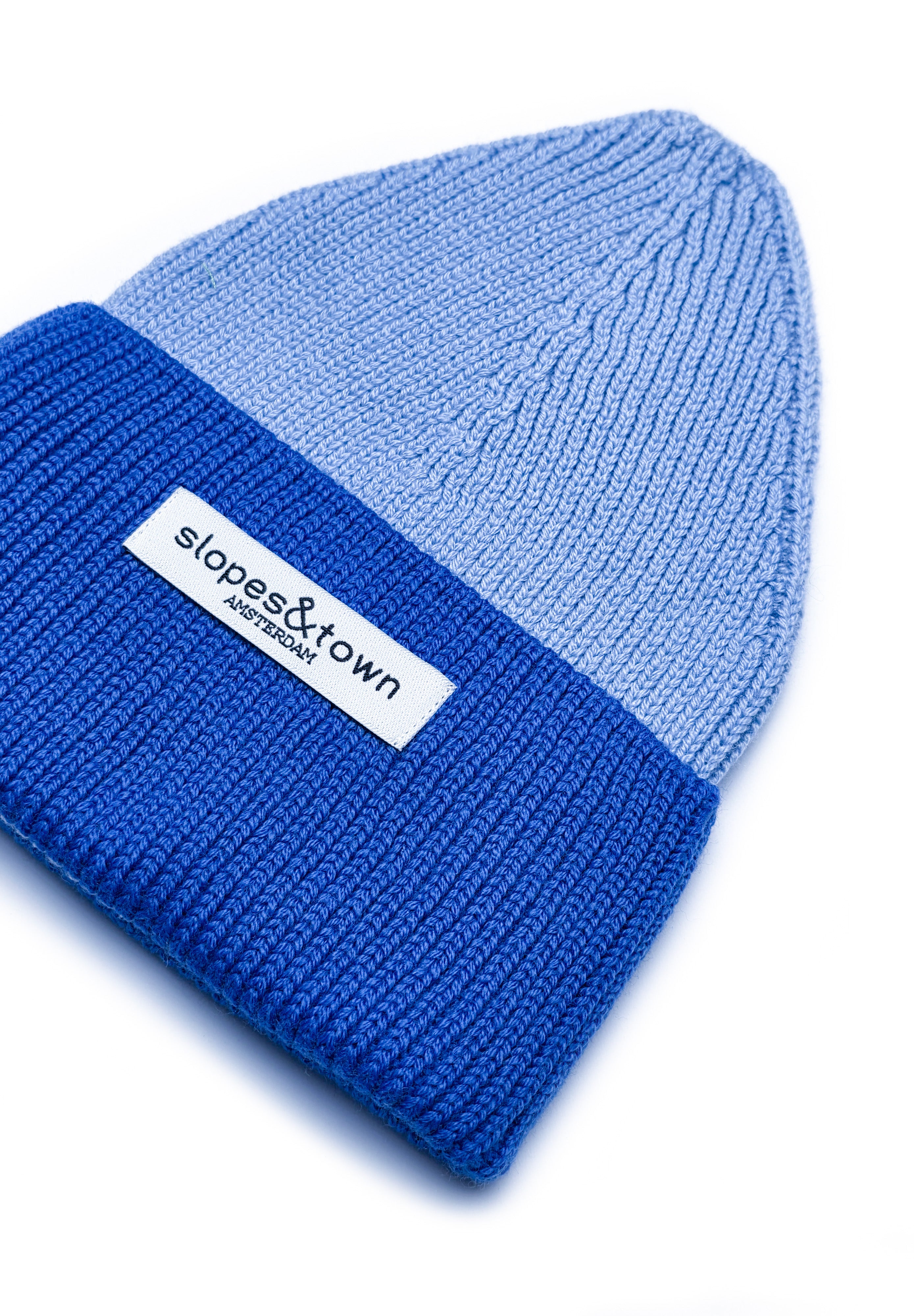 Close-up of merino wool knit on a blue kids beanie