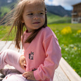 Child wearing pink organic cotton sweatshirt with embroidered cat design