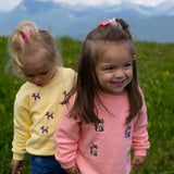 Child wearing pink organic cotton cat sweatshirt