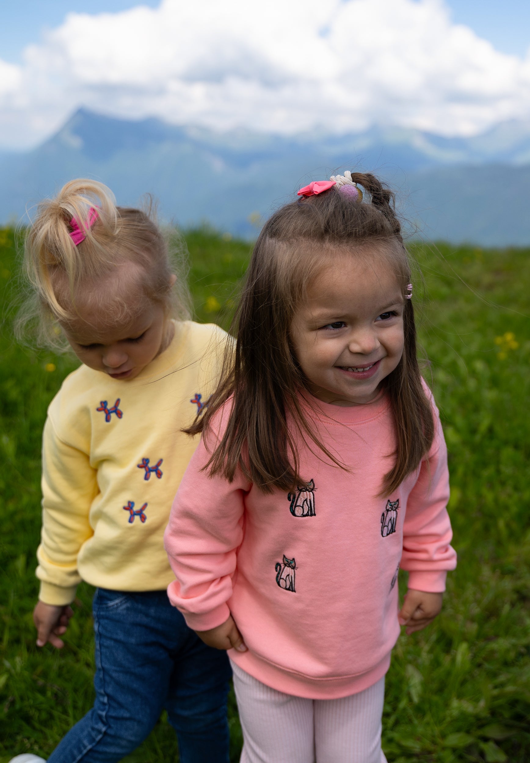 Child wearing pink organic cotton cat sweatshirt