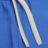 Blue organic cotton joggers with playful plane design for kids