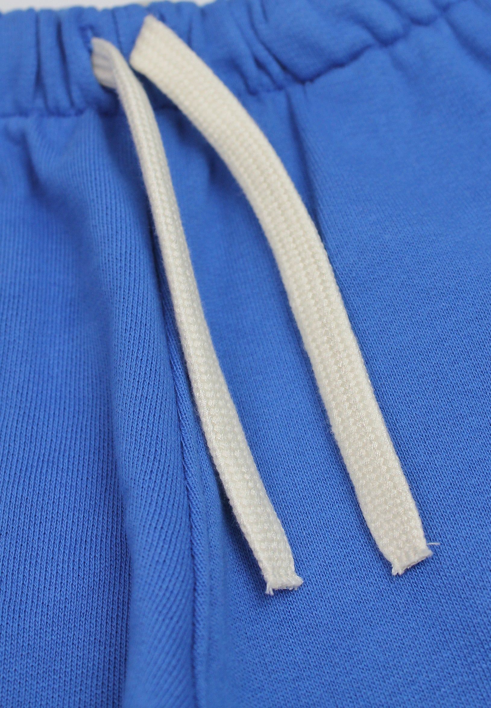 Blue organic cotton joggers with playful plane design for kids