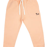 Slopes and Town Kids peach organic cotton sweatpants with embroidered sausage dog design