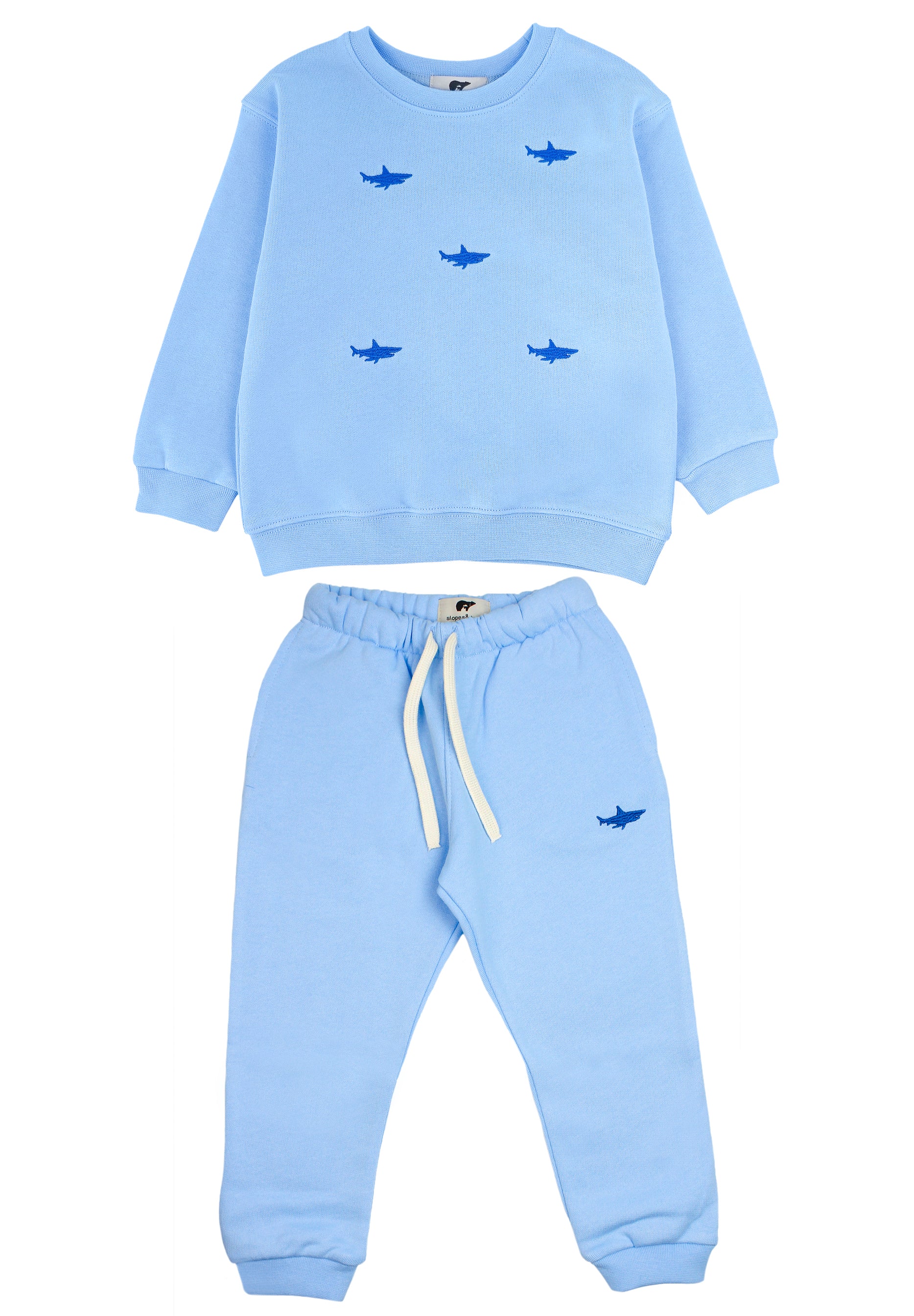 Child wearing blue sweatpants with matching shark sweatshirt