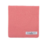 Kids merino wool snood in lemonade pink, front view with Slopes and Town Amsterdam woven label