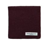 Kids merino wool snood in burgundy, front view with Slopes and Town Amsterdam woven label
