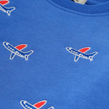 Close-up detail of airplane embroidery on blue kids' organic cotton sweatshirt